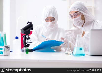 Two chemists working in the lab