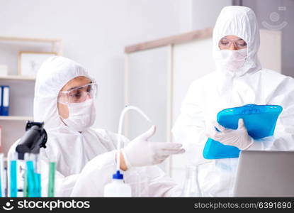 Two chemists working in the lab