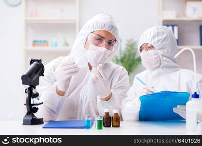 Two chemists working in the lab