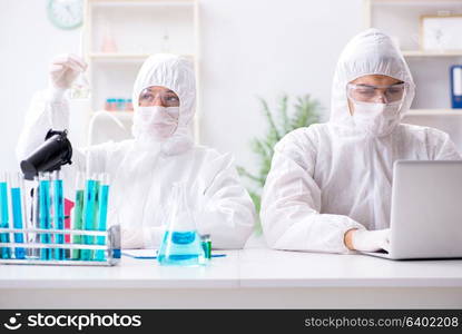 Two chemists working in the lab