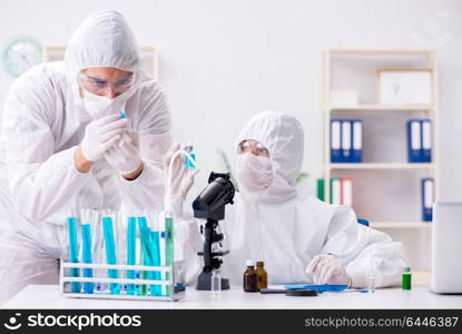 Two chemists working in the lab