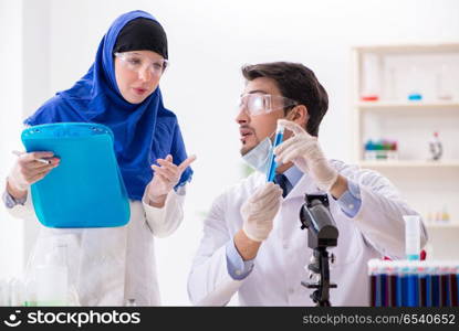 Two chemists working in the lab