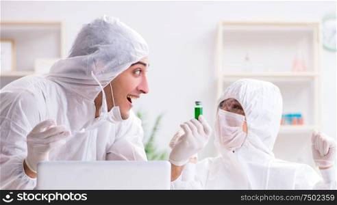 Two chemists working in the lab. The two chemists working in the lab