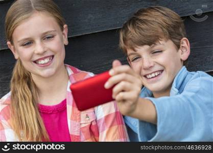 Two children boy and girl talking cell phone selfie photograph