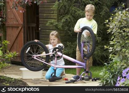 Two Children Cleaning Bike Together