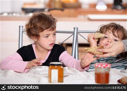 Two children eating breakfast