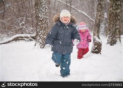 two children in forest in winter