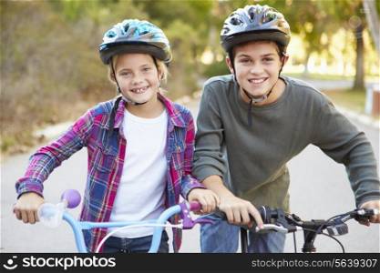 Two Children On Cycle Ride In Countryside