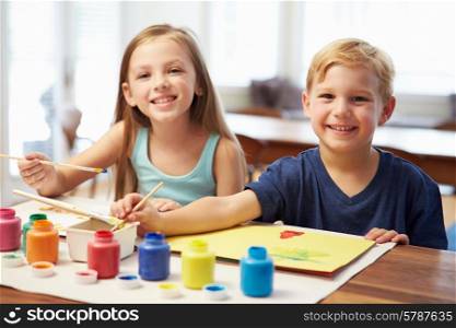 Two Children Painting Picture At Home