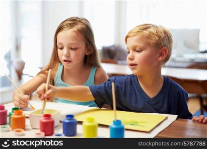 Two Children Painting Picture At Home