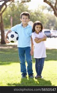 Two Children Playing Soccer Together