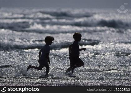 Two Children Running at the Beach