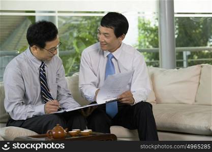 Two Chinese businessmen in a meeting