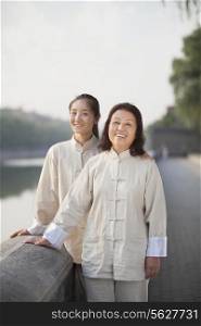 Two Chinese Women With Tai Ji Clothes Smiling At Camera