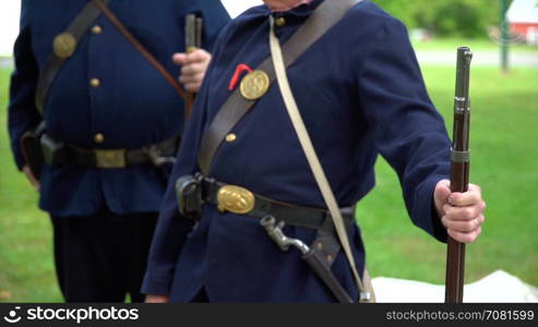 Two Civil War soldiers leaning on their rifles