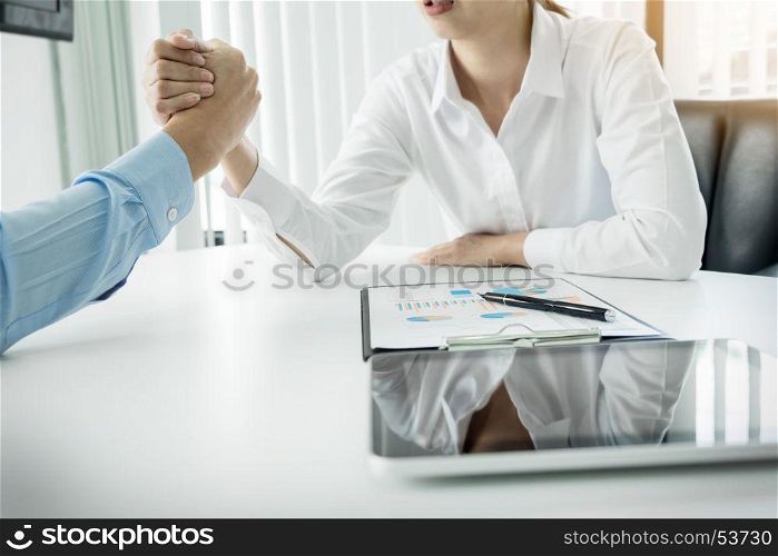 two clasped hands of businessmen.