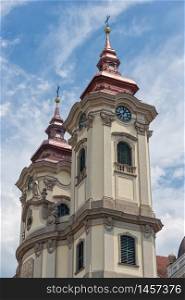 Two clock towers of Minorite church at Eger main square in Hungary. Clock towers Minorite church at Eger main square in Hungary