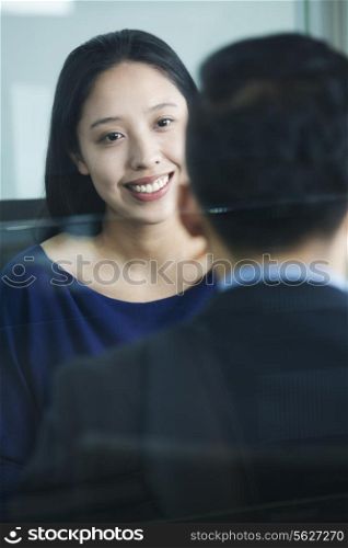 Two co-workers talking in office