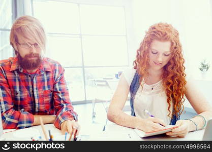 Two co-workers working together. Two co-workers working together in office