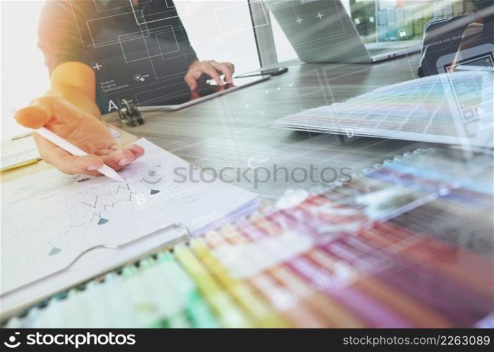 two colleagues interior designer discussing data and digital tablet and computer laptop with sample material and digital design diagram on wooden desk as concept