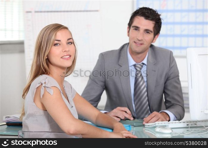 Two colleagues sat by computer