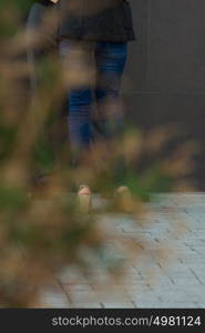 Two colleagues standing outdoors near office building and talking