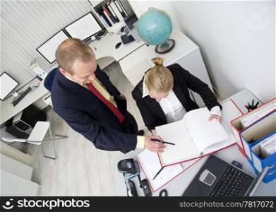 Two colleagues working together in a small office