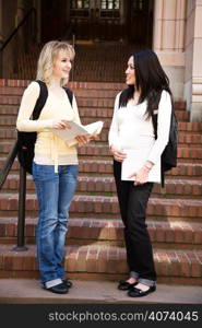 Two college students meeting and talking on campus