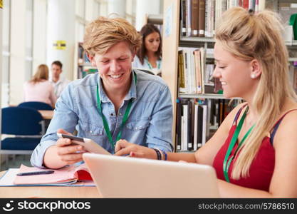 Two College Students Studying In Library Together