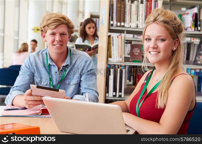 Two College Students Studying In Library Together
