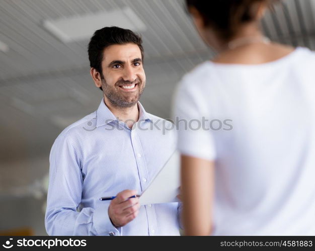 Two collegues having a talk in office