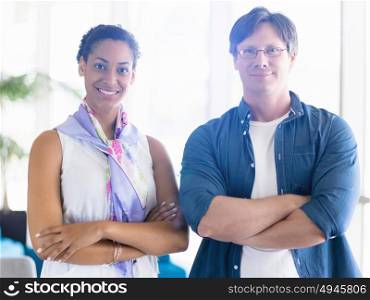 Two collegues standing next to each other in a office