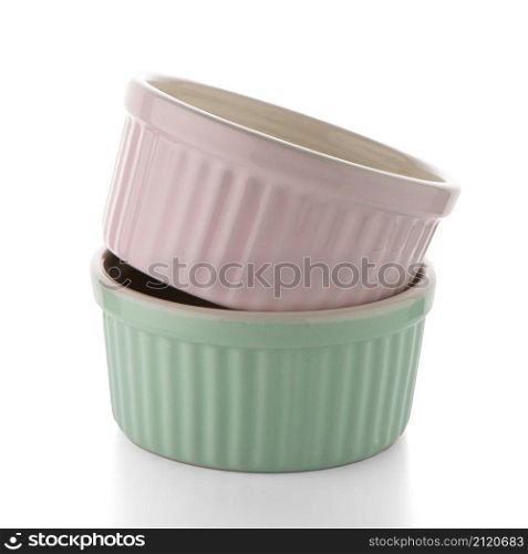 Two colored bowls on white reflective background