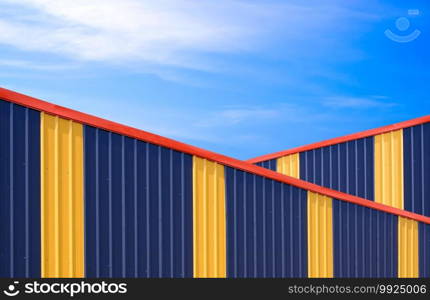 Two colorful alternately corrugated steel wall of industrial warehouse buildings against blue sky background in minimal style, Exterior architecture design concept 