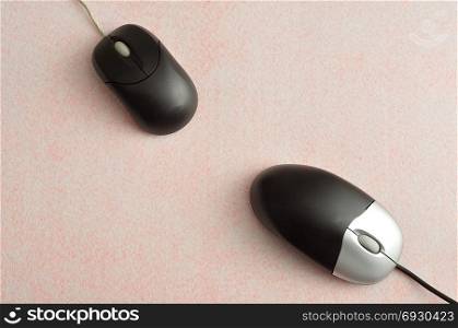 Two computer mouses isolated on a white background