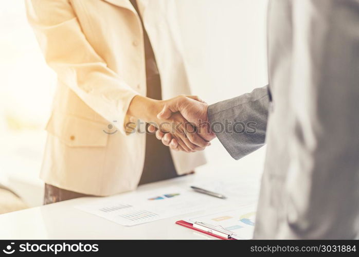 Two confident business man shaking hands during a meeting in the office, success, dealing, greeting and partner concept.