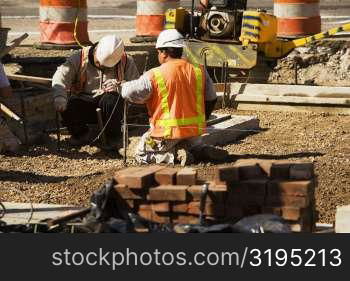 Two construction workers working at a construction site
