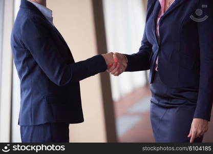 two corporate business woman at modern bright office interior make deal and handshake