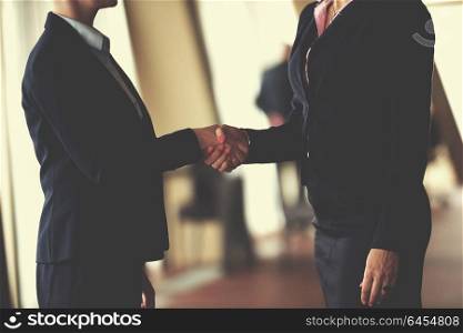 two corporate business woman at modern bright office interior make deal and handshake