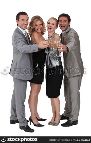 Two couples celebrating with champagne