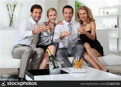 Two couples drinking champagne