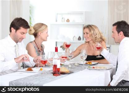 Two couples enjoying meal