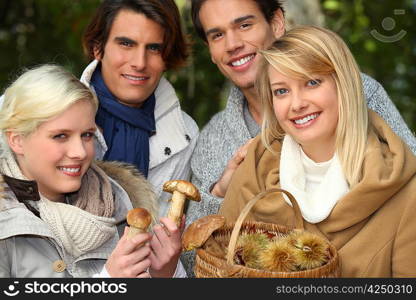 two couples gathering mushrooms