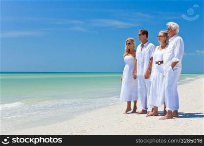 Two couples, generations of a family together holding hands on a tropical beach
