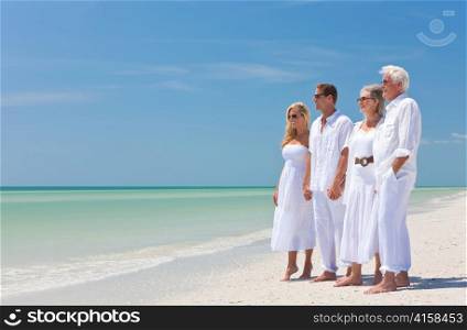 Two Couples Generations of Family Holding Hands on Tropical Beach