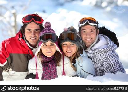 Two couples in a ski slope