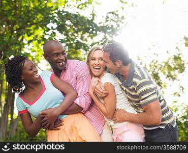 Two couples laughing in garden