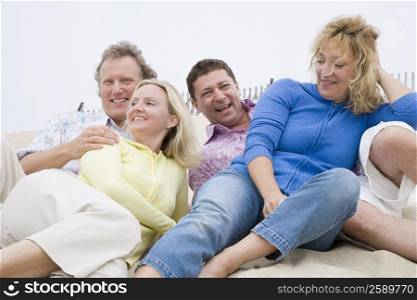 Two couples lying on the beach