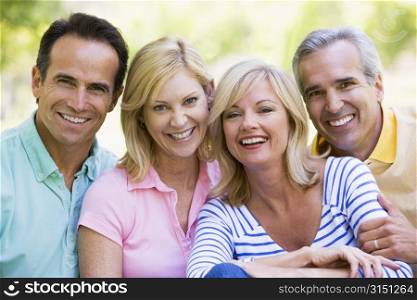 Two couples outdoors smiling