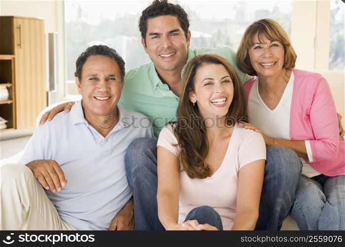 Two couples sitting in living room smiling